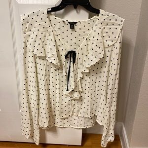 Polka dotted blouse with ruffles around the neck